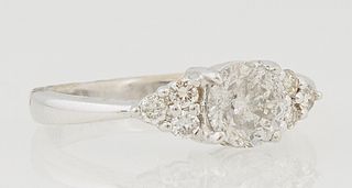 Lady's 18K White Gold Dinner Ring, with a central .92 carat round diamond flanked by triangular lugs with three round diamonds each,...