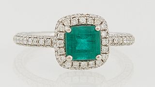 Lady's 14k White Gold Dinner Ring, with an octagonal step cut, 1.13 carat emerald atop a border of tiny diamonds, supported by a dia...