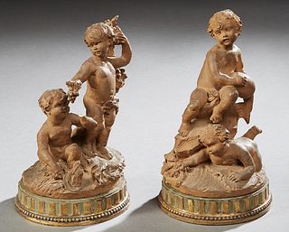 Pair of Terra Cotta Figural Groups of Frolicking Putti, late 19th c., signed indistinctly, on stepped composition bases, Taller- H.-...