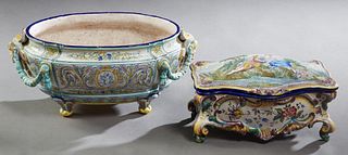 Two Pieces of French Style Polychromed Faience, consisting of an oval table jardiniere, 19th c., with garland draped applied masque handles, the flora