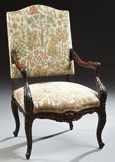 French Louis XV Style Carved Walnut Fauteuil, 19th c., the arched canted upholstered high back over well carved floral and leaf arms to an upholstered