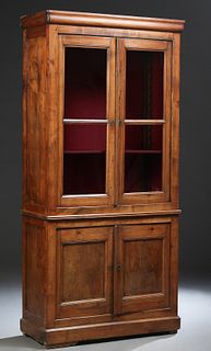 French Louis Philippe Carved Cherry Bookcase Cupboard, 19th c., the rounded crown over double glazed doors, atop a base with two cupboard doors, on a 