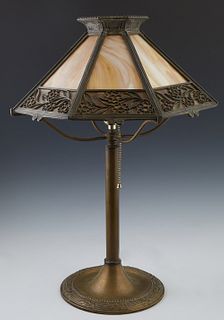 American Brass Slag Glass Table Lamp, c. 1920, by Bradley & Hubbard, the sloping octagonal caramel slag glass shade with floral relieg decoration, on 