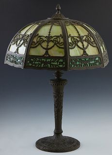 Salem Brothers Spelter and Iron Slag Glass Table Lamp, c. 1920, New York, the curved octagonal green glass spelter shade with dark green glass lower i