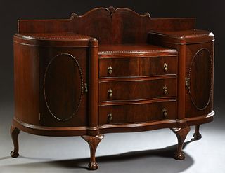 Carved Mahogany Serpentine Bow Front Sideboard, early 20th c., with a shaped back splash over a central drop well, above three deep drawers, flanked b