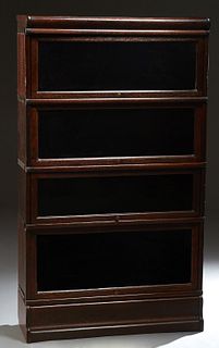 Globe Wernicke Carved Oak Four Stack Barrister Bookcase, c. 1910, with the base and crown, H.- 64 in., W.- 34 in., D.- 12 3/4 in. Provenance: from a c