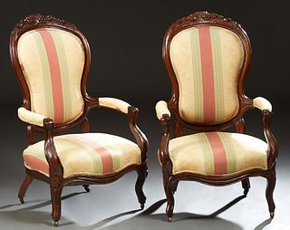 Pair of American Victorian Carved Mahogany Upholstered Fauteuils, c. 1880, the fruit and leaf carved canted upholstered backs, to upholstered arms and