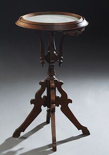 American Carved Walnut Circular Fern Stand, c. 1880, with an inset white marble top on four cabriole supports to a turned central shaft, the whole on 