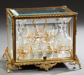 Gilt Bronze and Cut Glass Cave a Liqueur, 19th c., the case with beveled glass top and sides, the interior with a lift out gilt bronze tray fitted for