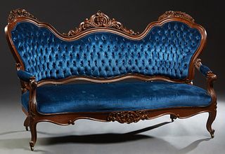 American Rococo Revival Carved Mahogany Settee, 19th c., the serpentine chair back with three pierce carved floral crests, over a tufted upholstered b