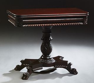 American Carved Mahogany Games Table, c. 1850, possibly Philadelphia, with a gadrooned skirt with floral carved rounded edges, on a leaf carved suppor