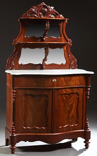 American Victorian Carved Walnut Marble Top Sideboard, c. 1880, with a shaped arched floral and scrolled leaf form crest above a mirrored back backing