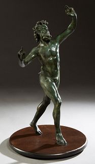 Continental School, "The Dancing Satyr," 20th c., patinated bronze, after the Roman original discovered in Pompeii in 1830, on a circular wooden plint