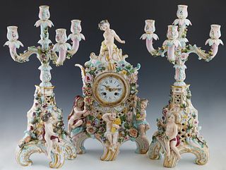 Three Piece Meissen Style Porcelain Four Seasons Figural Clock Set, 19thc., the flower encrusted clock , with an enamel dial, time and strike, by Japy
