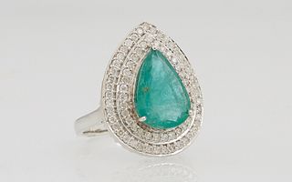 Lady's 18K White Gold Dinner Ring, with a 3.95 carat pear shaped emerald, atop a conforming double concentric border of 2 point round diamonds, Total 
