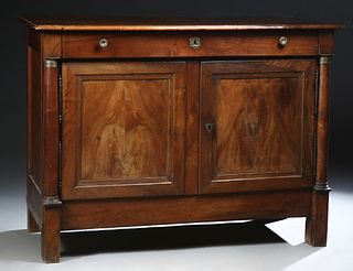 French Empire Style Carved Walnut Sideboard, mid 19th c., the stepped rounded edge top over a setback frieze drawer, over double setback cupboard door