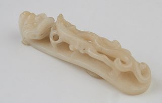 Chinese White Jade Belt Buckle, 19th c., with pierced dragon motif carving, H.- 1 in., W.- 5 1/2 in., D.- 1 1/4 in. Provenance: from a collection of a