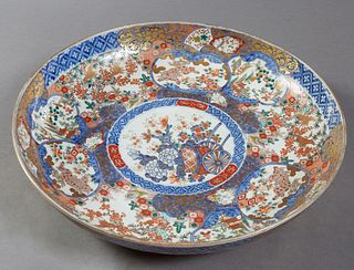 Large Chinese Porcelain Charger, 19th., with a blue and gilt border around bird and floral decoration and panel decorations of clouds and gardens, the