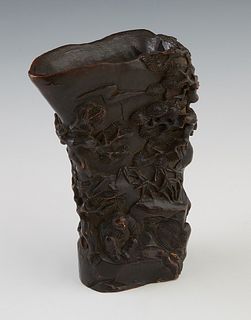 Chinese Carved Wood Libation Cup, 19th c., with figural and tree relief carving, H.- 5 7/8 in., W.- 4 3/8 in., D.- 2 1/2 in. Provenance: from a collec
