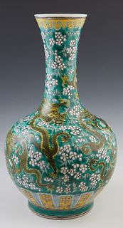 Chinese Green Porcelain Baluster Vase, 19th c., with an everted rim over sides with five toed dragon and floral decoration, the bottom with an undergl