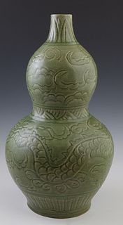Chinese Green Crackle Glaze Double Gourd Vase, Longquan period, the sides with incised cloud and dragon decoration, H.- 16 1/4 in., Dia.- 9 in. Proven
