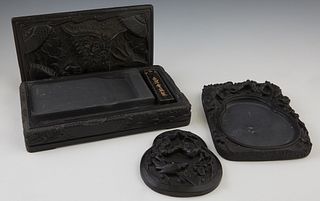 Two Chinese Carved Inkstones, 20th c., with dragon carved removable lids, Larger- H.- 2 in., W.- 9 1/2 in., D.- 5 3/4 in., Smaller- H.- 2 in., W.- 7 1