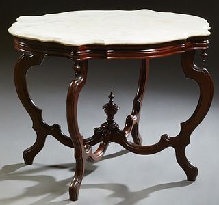 American Carved Mahogany Marble Top Center Table, c. 1870, the ogee edge white tortoise shaped marble on a reeded skirt with corner finials, on cabrio