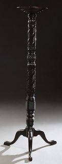 American Carved Mahogany Torchere, early 20th c., the dished circular top on a turned, carved and twist carved support, to tripodal cabriole legs, wit