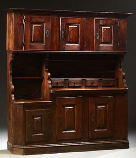 Unusual French Provincial Carved Oak Buffet a Deux Corps, 19th c., the stepped crown over three fielded panel cupboard doors with iron escutcheons and