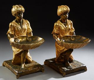 Pair of Gilt and Patinated Composition Blackamoor Card Trays, 20th c., kneeling on pillow form bases on four feet, H.- 20 in., W.- 10 in., D. - 15 in.