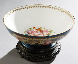 Sevres Circular Center Bowl, one side with a reserve of putti and ribbon garlands, the other with a floral reserve, the interior with a central floral