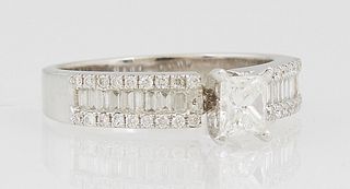 Lady's 18K White Gold Dinner Ring, with a central round .38 ct. diamond above shoulders with a center row of baguette diamonds flanked by outer bands 
