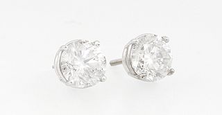 Pair of 14K White Gold Diamond Stud Earrings, each with a 1.25 carat round diamond, total diamond wt.- 2.5 cts., with appraisal.
