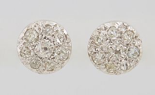 Pair of 18K White Gold Stud Earrings, each circular domed screwback stud with a central mine cut diamond within a border of seven smaller mine cut dia