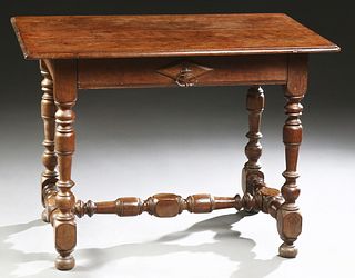 French Provincial Louis XIV Style Carved Walnut Writing Table, c. 1800, the rounded edge and corner top over a single long frieze drawer, on turned tr