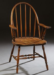American Carved Oak Windsor Armchair, late 19th c., the arched curved spindled back over scrolled flat arms, on turned tapered splayed legs joined by 