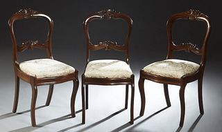 Set of Three American Carved Mahogany Medallion Back Side Chairs, c. 1910, with upholstered slip seats, on saber legs, H.- 34 1/2 in. Provenance: from