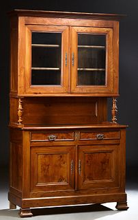 French Louis Philippe Carved Elm Buffet a Deux Corps, 19th c., the stepped crown over double glazed doors on turned tapered supports, to a rounded cor