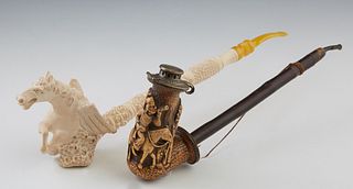 Two Carved Meerschaum Pipes, 20th c., one with a winged horse bowl; the second lidded, with a relief figural carved bowl exterior, Horse- 14 1/2 in., 