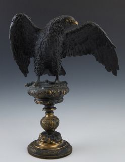 Patinated Brass Spread Wing Eagle, early 20th c., on a socle support to a stepped relief circular base, H.- 16 1/2 in., W.- 13 1/2 in., D.- 8 1/2 in. 