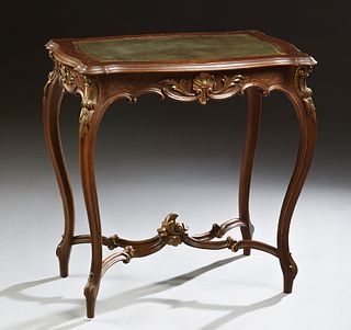 French Louis XV Style Carved Oak Side Table, early 20th c., the stepped tortoise top with an inset gilt tooled leather insert, on cabriole legs joined