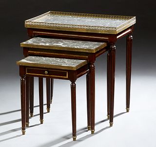 Nest of Three French Louis XVI Style Marble Top Tables, early 20th c., the largest with a highly figured gray marble with a reticulated brass gallery,