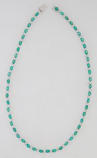 18K White Gold Link Necklace, each of the 50 links with a graduated oval emerald joined by a floriform link mounted with six small round diamonds, tot