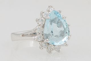 Lady's Platinum Dinner Ring, with a pear shaped aquamarine atop a border of diamond mounted "points," on a split shoulder band, total diamond wt.- .83
