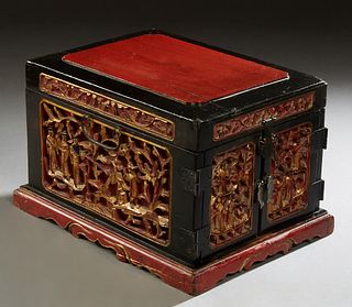 Chinese Red and Black Lacquered Jewelry Box, early 20th c., the lid lifting to a removable easel mirror, over gilt relief carved sides, the front with