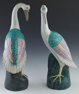 Pair of Chinese Polychromed Porcelain Cranes, 20th c., on integral post stands, the underside stamped with an indistinct red triangle mark, H.- 20 in.