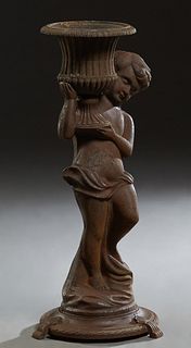 Cast Iron Figural Planter, 20th/21st c., of a putto upholding a campana form urn planter, on a stepped circular base with four flat splayed legs, H.- 