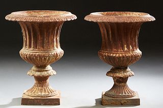 Pair of Cast Iron Campana Form Garden Urns, 20th c., the everted relief rims over reeded sides, to a socle support, on an integral square base, H.- 16