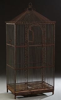 Large Cast Iron Parrot Cage, 21st c., the sloping top with scrolled bars, over barred sides with a large single center door, above the bottom with a r