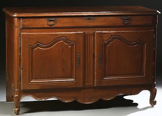 French Provincial Carved Cherry Sideboard, 19th c., the stepped rounded edge and corner top over a long frieze drawer and double arched fielded panel 